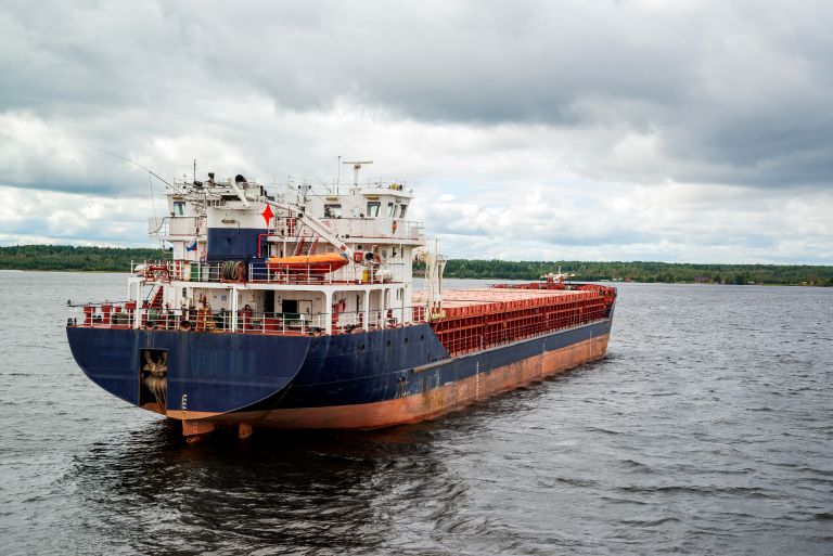 Bulk carrier vessel underway on inland water, used in commercial marine operations